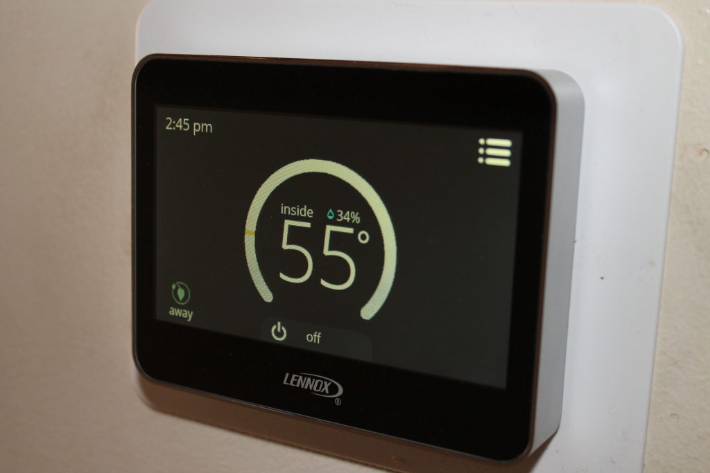 Lennox thermostat showing 55 degrees, installed by Fenix Heating & Cooling in Wichita