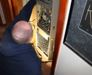 Fenix heating technician replacing an old Lennox furnace in a Wichita home