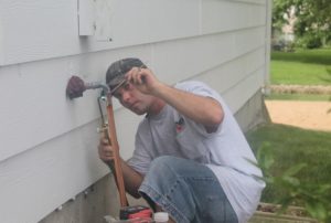 Fenix technician working on the installation of a new air conditioner at a West Wichita home