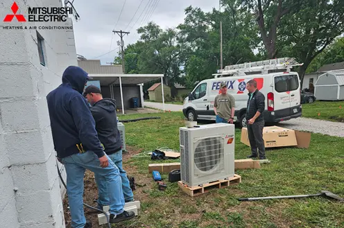 hvac-technicians-installing-mitsubishi-electric-outdoor-unit
